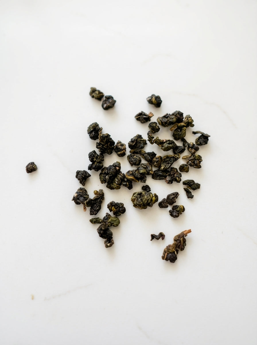 Dried black tea leaves on a white background