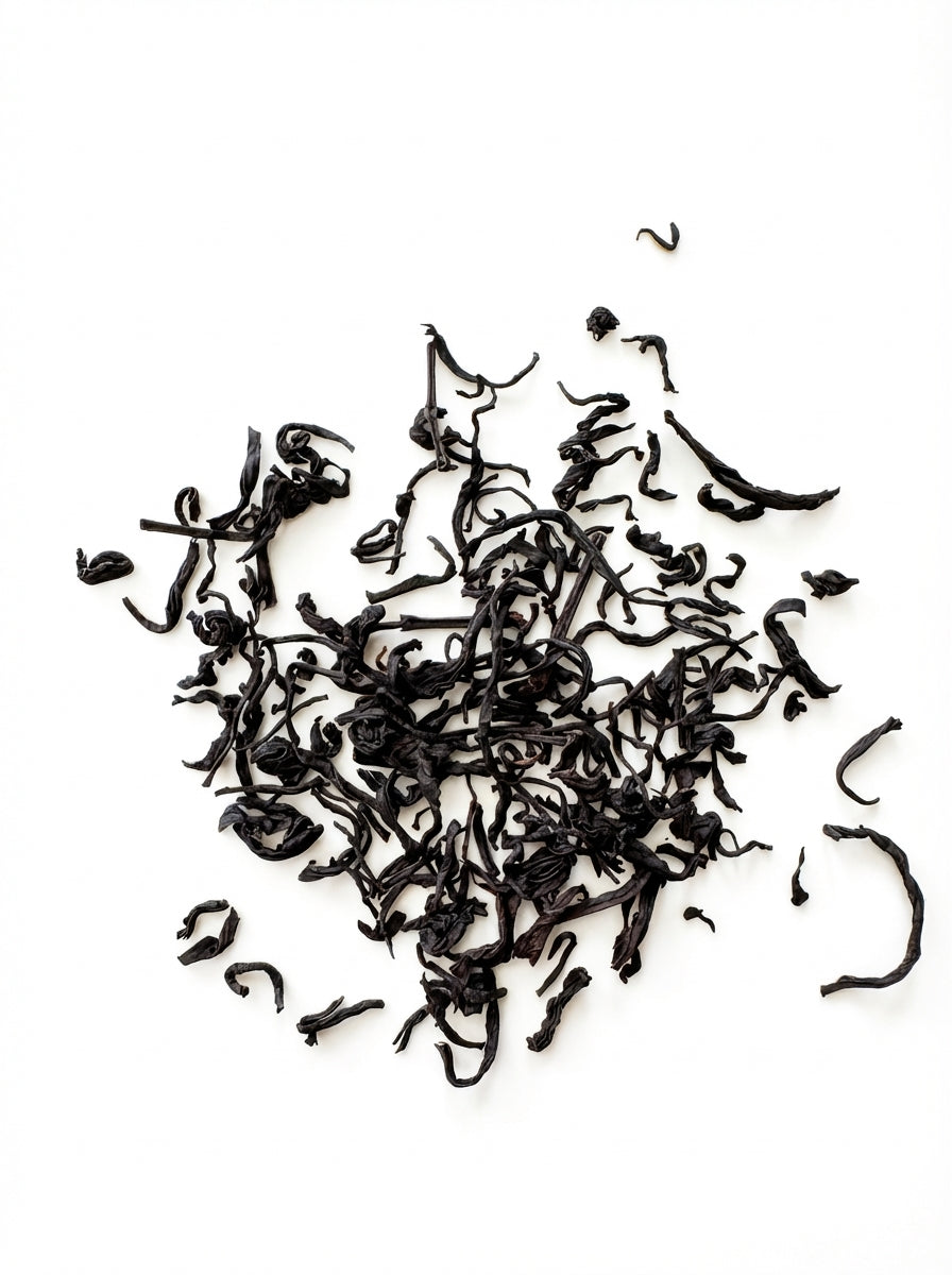 Black tea leaves on a white background